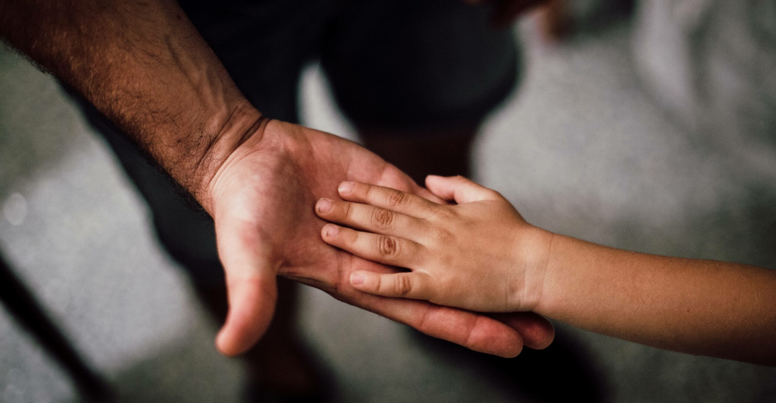 man holding child hand