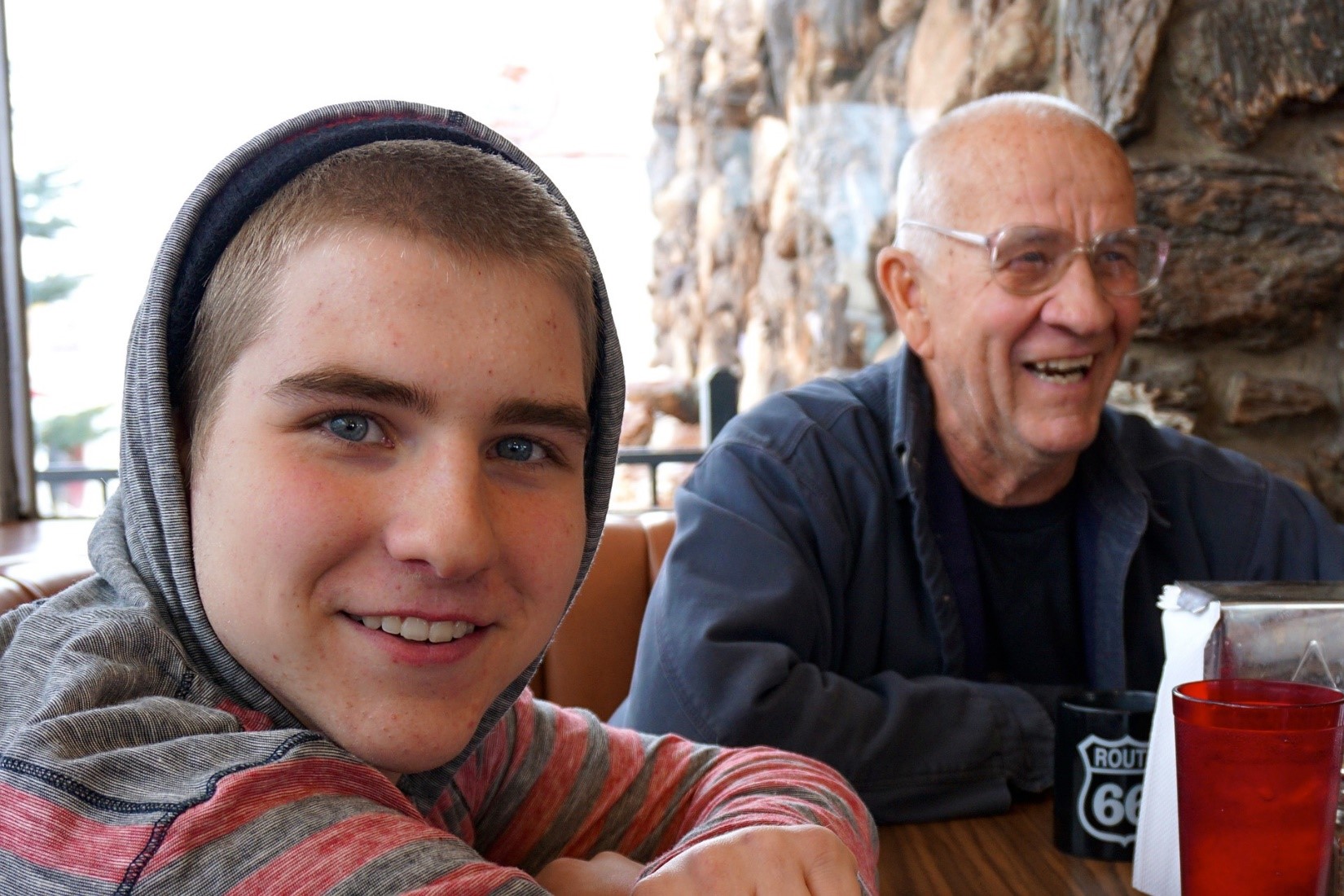 young male adult and adult smiling